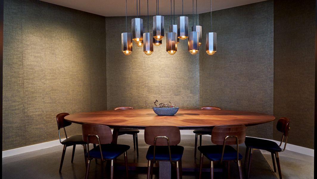 A dark wood table in a conference room at the Ameswell Hotel