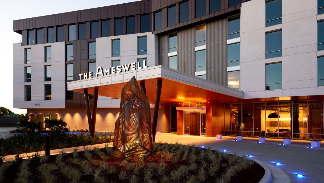 The exterior entrance of the Ameswell Hotel in the twilight